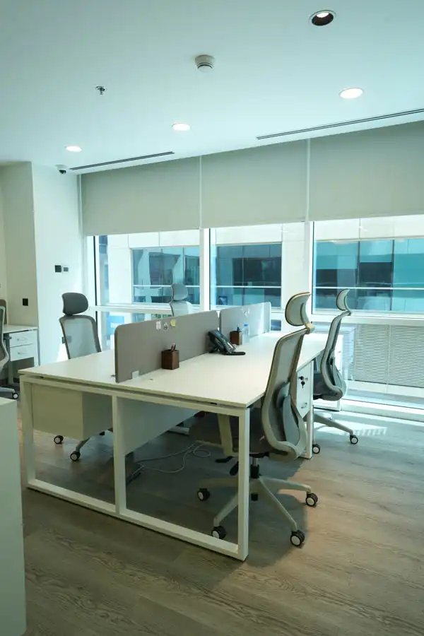 Workstation area fit-out by Blueprint Experts – bright office with ergonomic chairs, desks, and natural light.