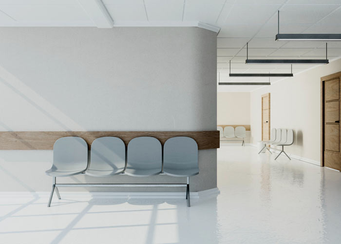 Hospital waiting area fit-out by Blueprint Experts – minimal seating arrangement with clean white flooring and walls.