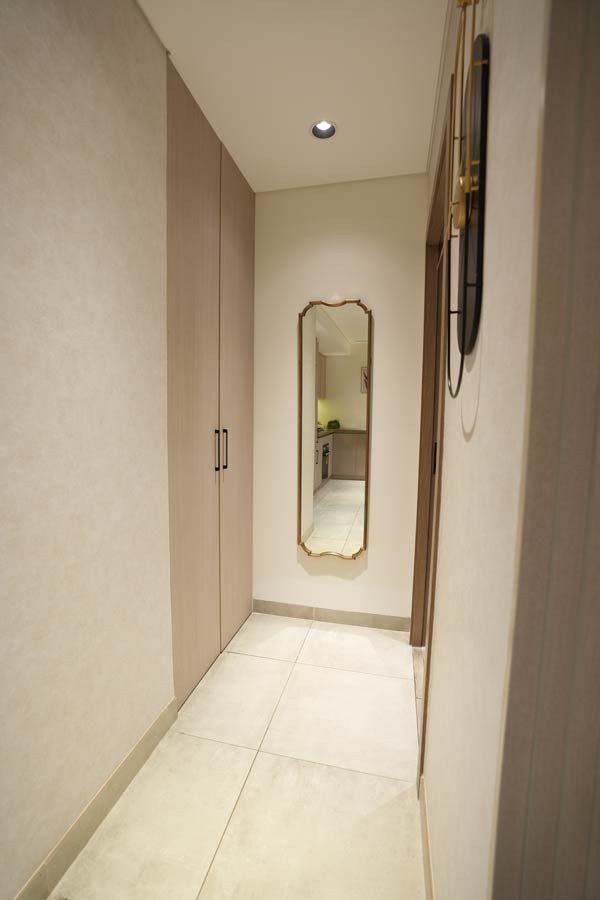 Narrow hallway with full-length mirror and minimalist design by Blueprint Experts