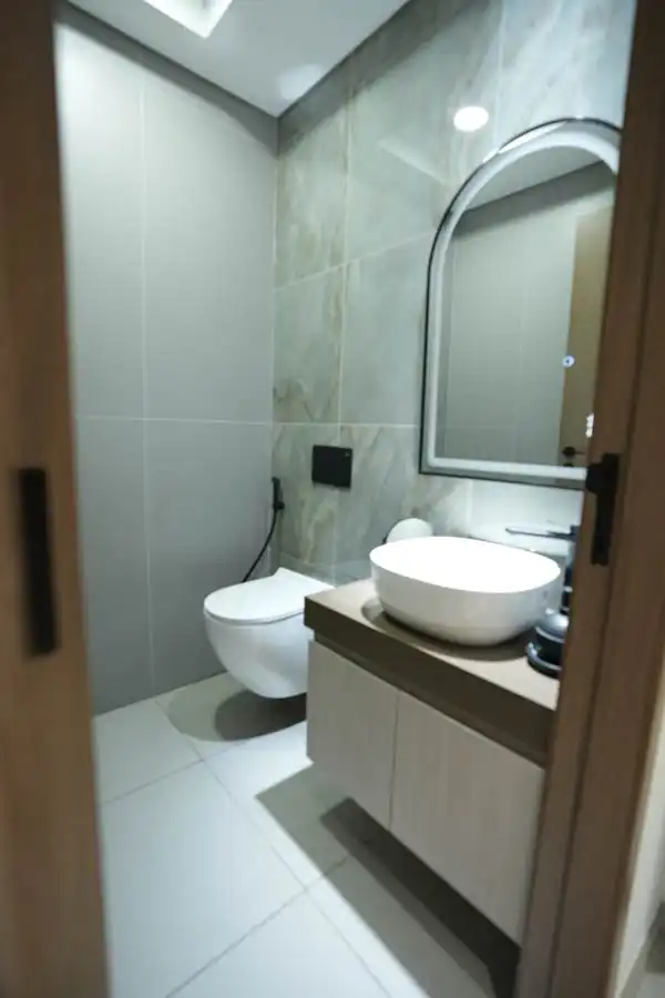 Compact and elegant bathroom with wall tiles and floating vanity