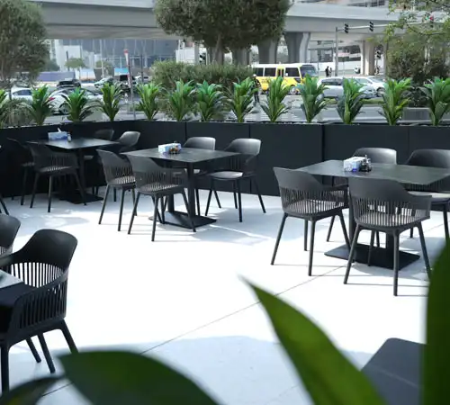 Street-style cafe interior with natural light and casual seating by Blueprint Experts.