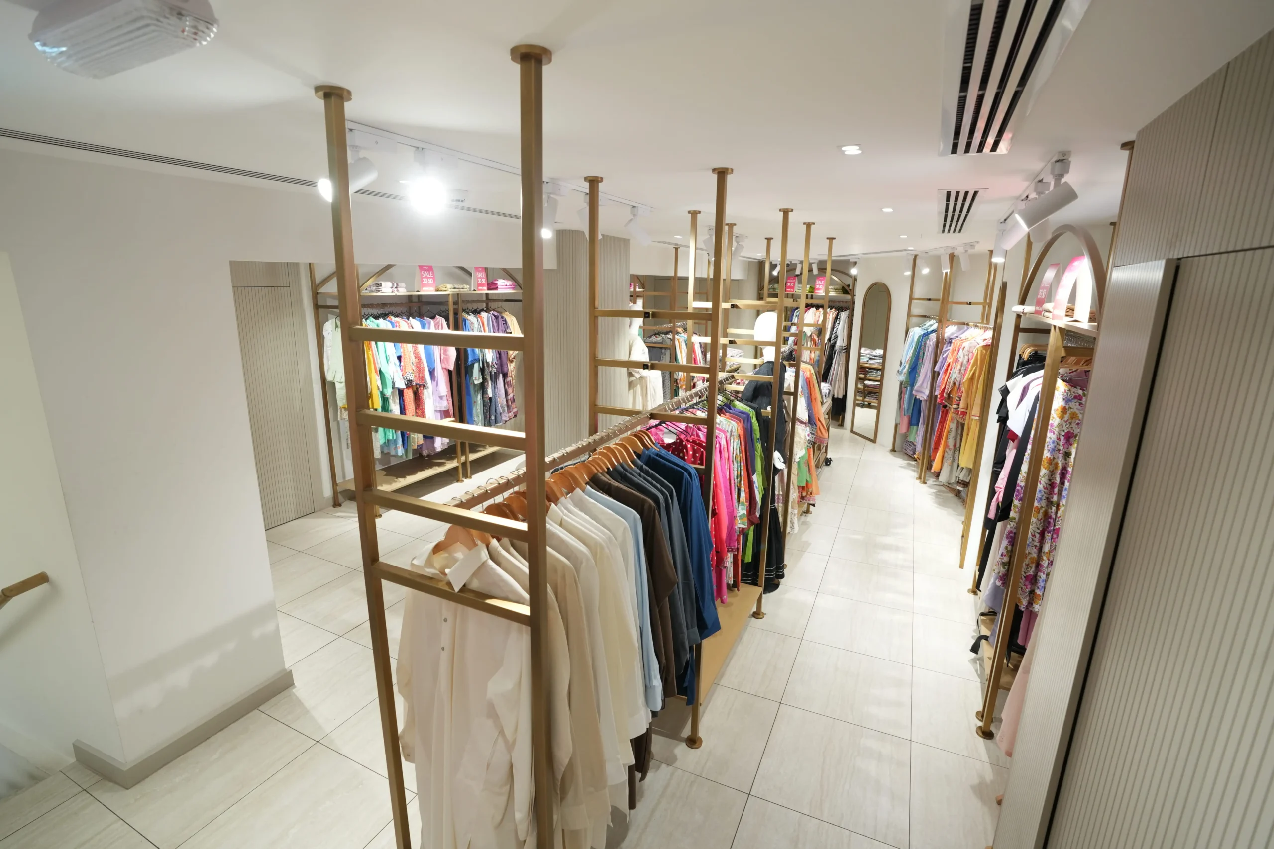 Retail store fit out with premium wardrobe racks, lighting design and space planning by Blueprint Experts interior fit out company