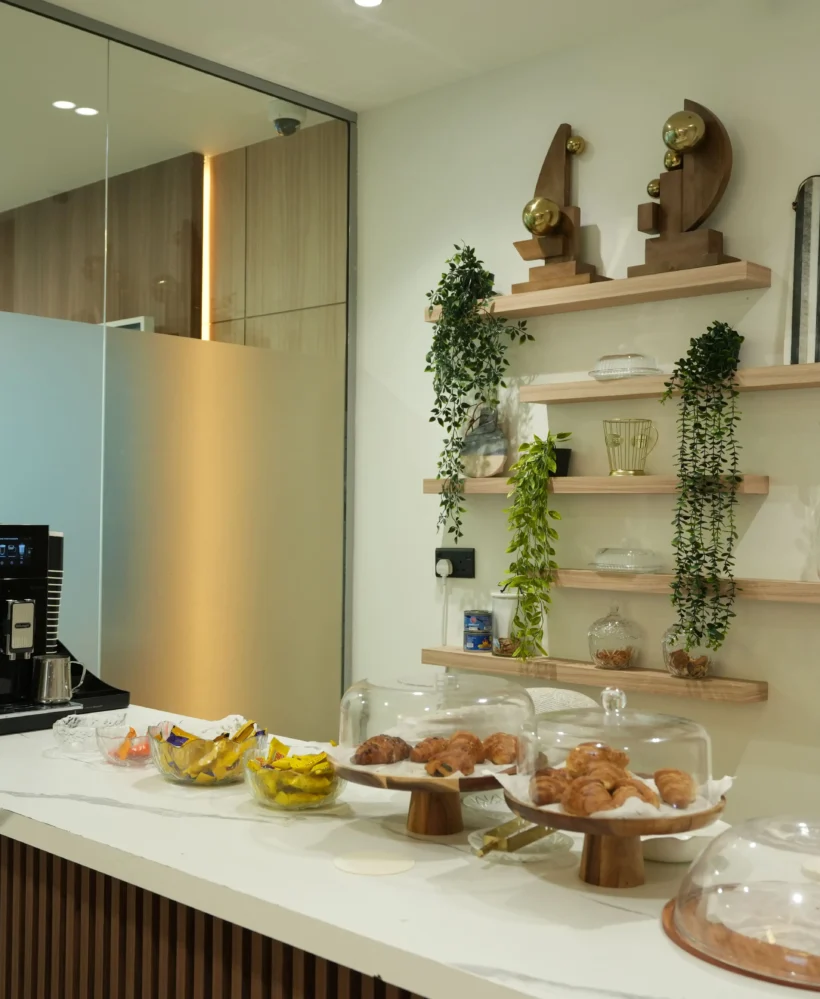 Office pantry fit out with coffee station setup, wooden wall shelves and countertop service area
