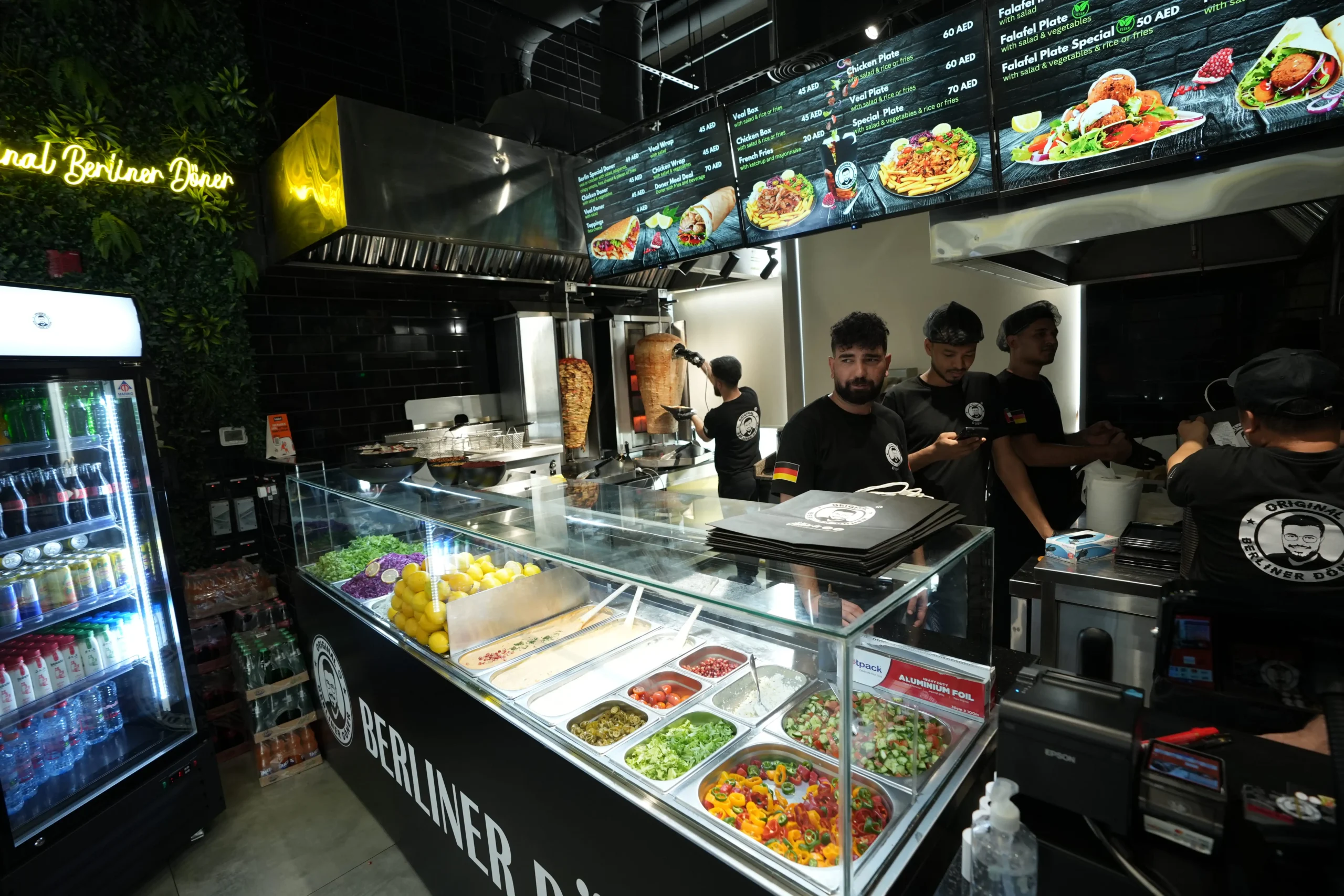 Commercial kitchen fit out with live cooking counter, food display units and menu board installation