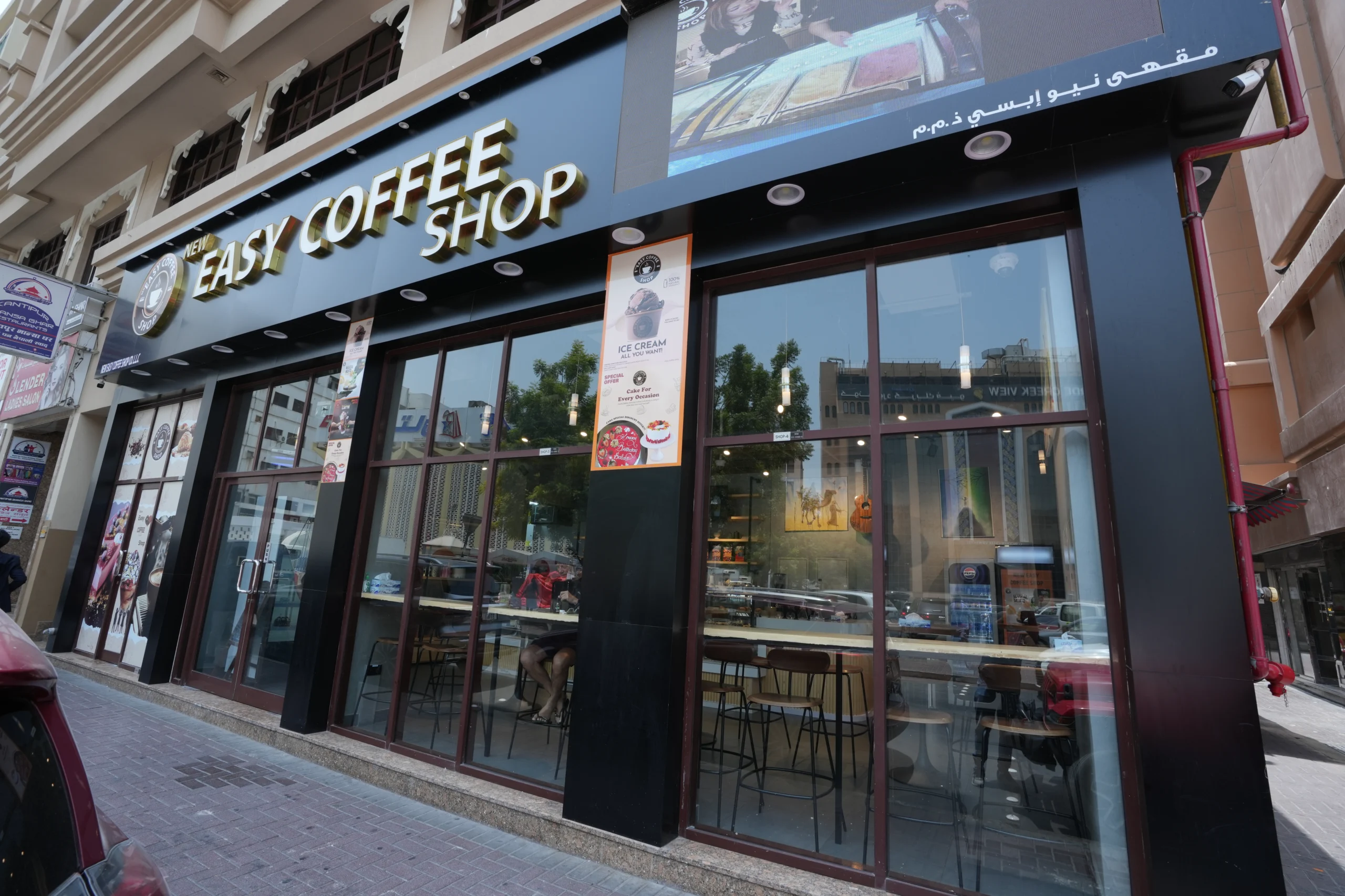 Coffee shop exterior fit out with full glass façade, storefront signage and modern café entrance design by Blueprint Experts Dubai
