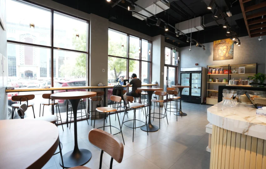 Café interior fit out with modern seating, natural lighting and comfortable dining space design by Blueprint Experts Dubai