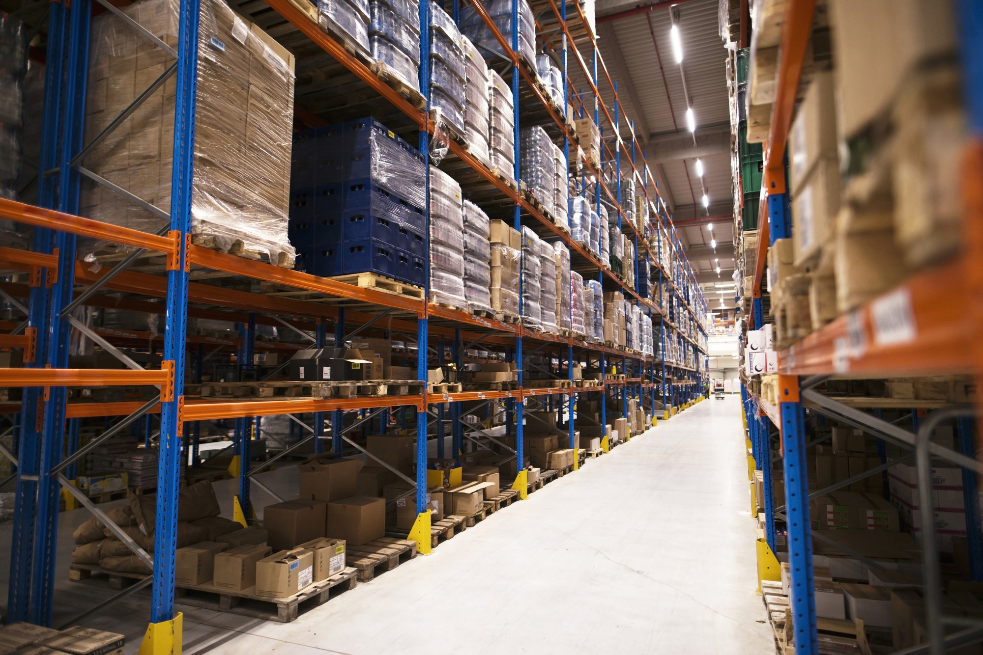 Industrial warehouse interior fit-out by Blueprint Experts – high-bay racking system with organized pallets, wide aisles, and efficient storage layout for logistics and warehousing operations.