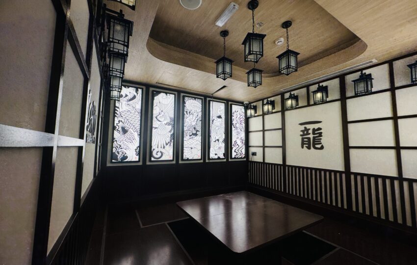 Japanese restaurant interior fit out with custom joinery, tatami-style seating, decorative paneling and ambient lantern lighting by Blueprint Experts Dubai