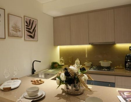 Interior fit out for modern kitchen with custom cabinetry, countertop installation and warm ambient lighting by Blueprint Experts